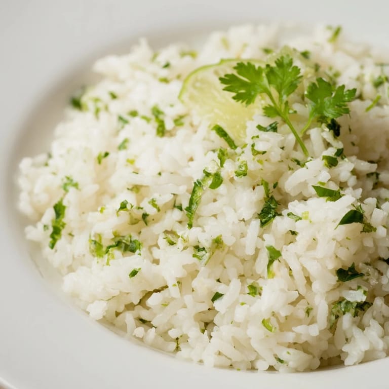 Close-up of bright green Cilantro Lime Rice, showcasing the fluffy texture and fresh flavors.